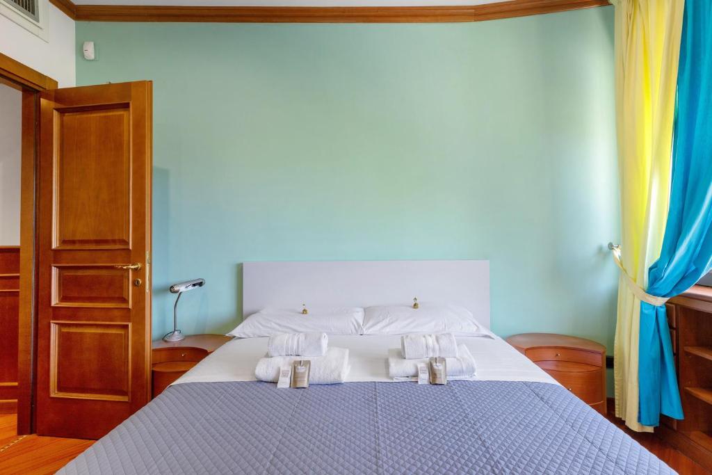 Camera con pareti verde salvia e letto matrimoniale