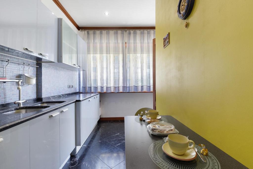 Cucina con tavolo, luce naturale e stoviglie